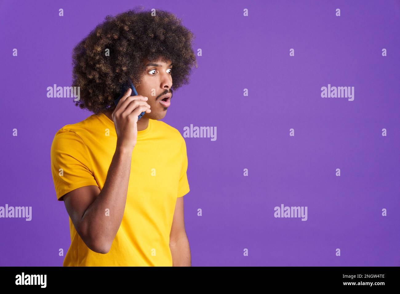 Surprised african man talking to the mobile Stock Photo
