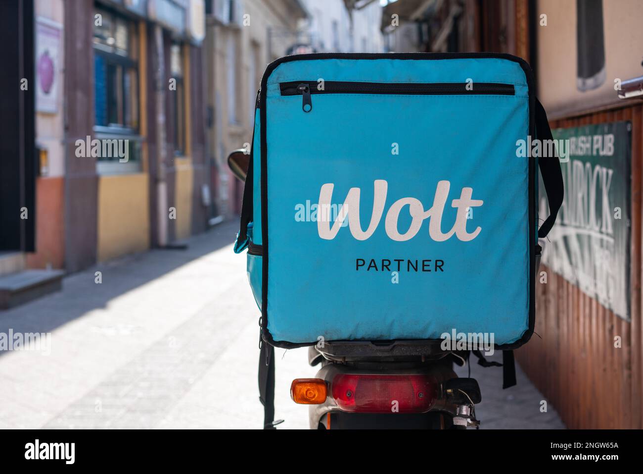 Blue thermo bag with on motorbike of courier of Wolt delivery food and merchandise company. Stock Photo