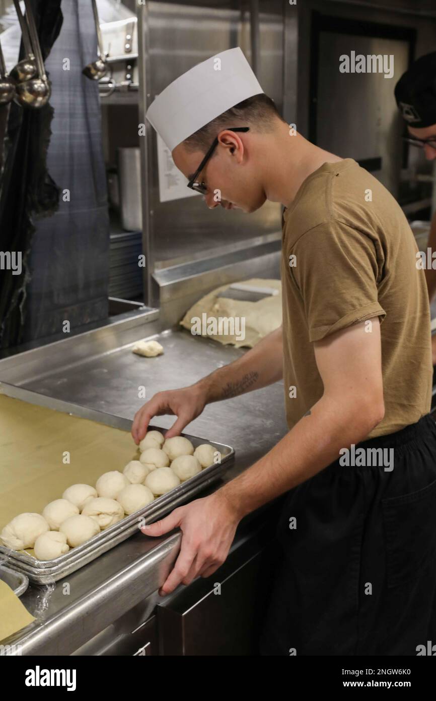 Culinary Specialist Seaman Dominic Hughes prepares bread rolls before