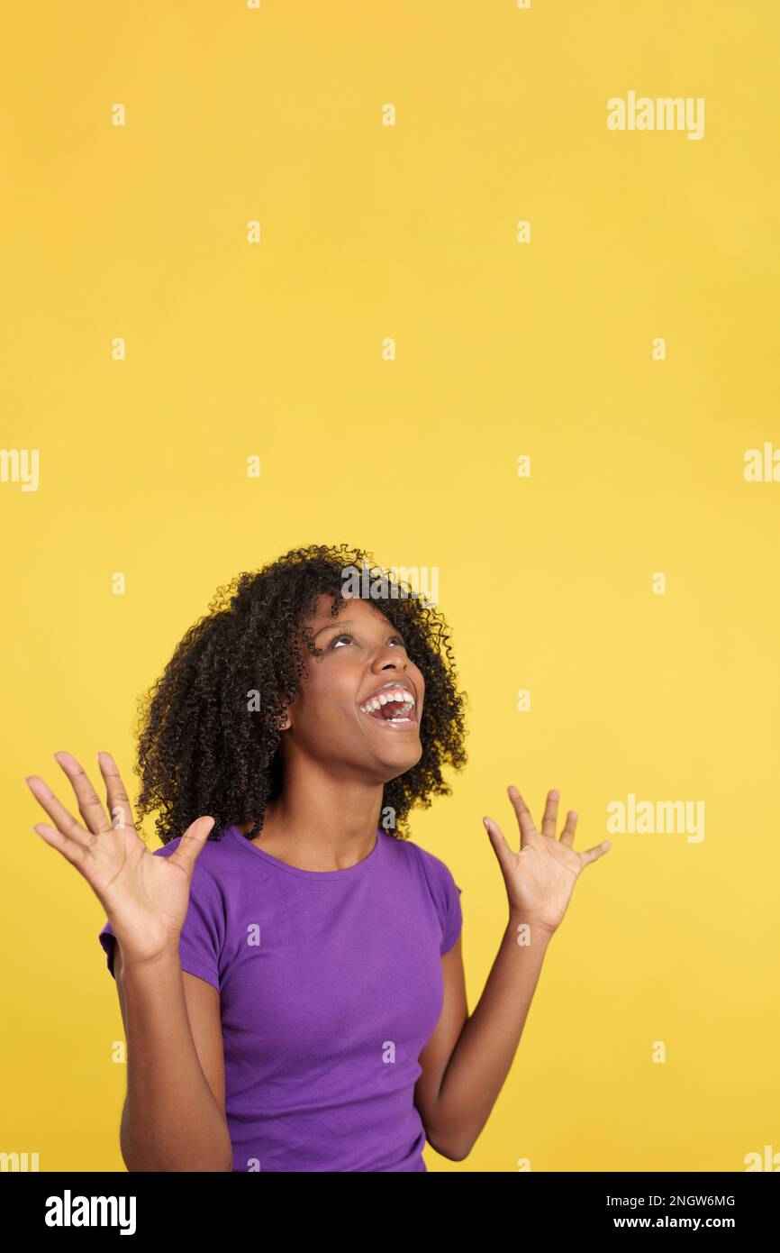 Cool woman with afro hair gesturing happiness looking up Stock Photo ...