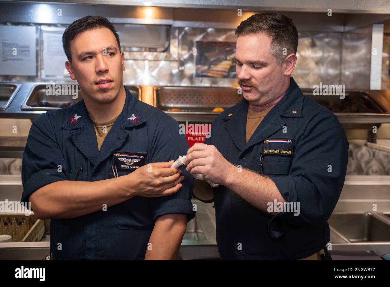 221125NUF5921047 PHILIPPINE SEA (Nov. 25, 2022) Lt. Cmdr. Christopher Foran, right, from