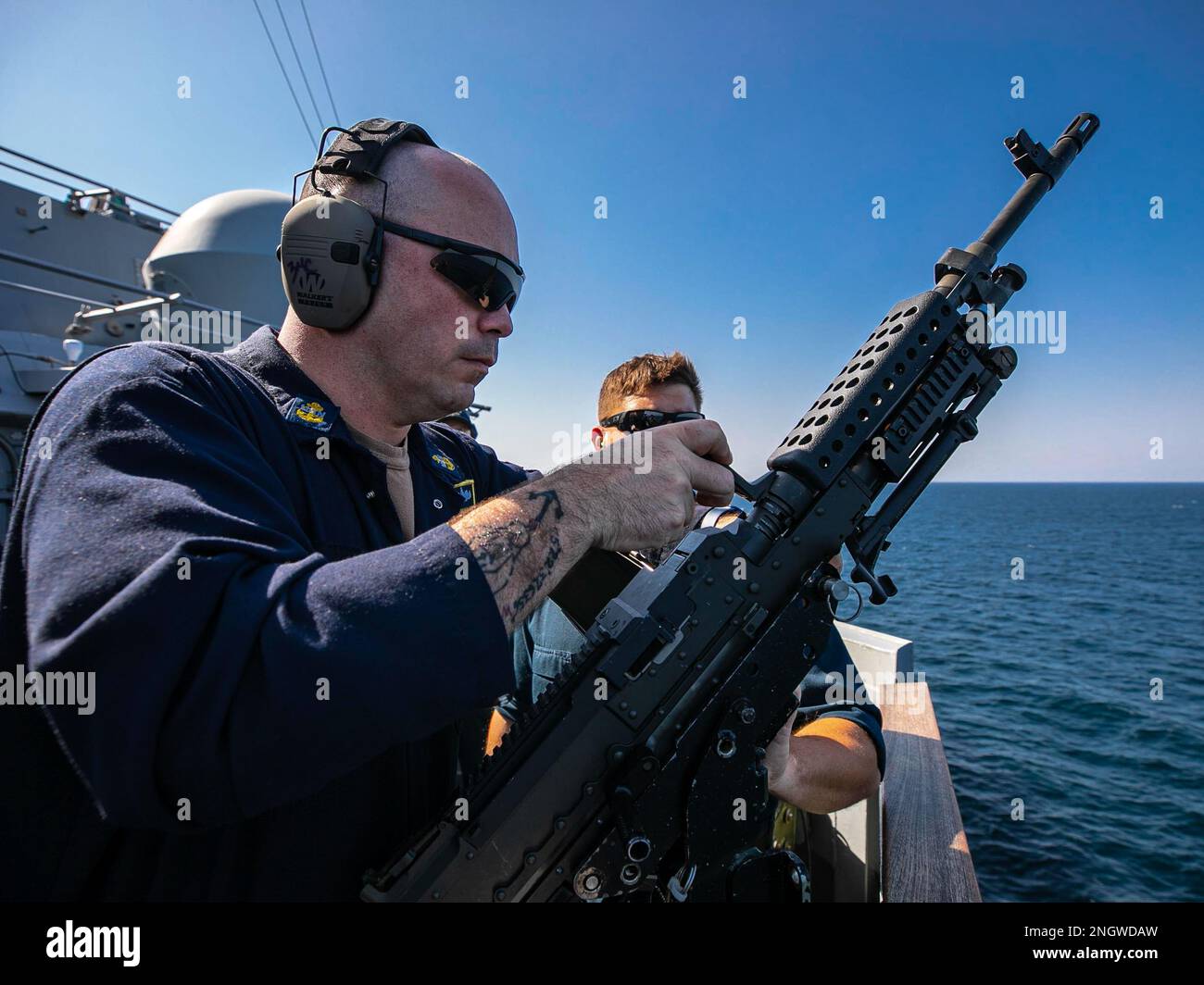 221127-N-UL352-1327 ARABIAN GULF (Nov. 27, 2022) Chief Fire Controlman Matthew McQuade, assigned to the guided-missile destroyer USS Delbert D. Black (DDG 119), changes the barrel of an M240B machine gun during a live-fire weapons qualification shoot in the Arabian Gulf, Nov. 27. Delbert D. Black is deployed to the U.S. 5th Fleet area of operations to help ensure maritime security and stability in the Middle East region. Stock Photo