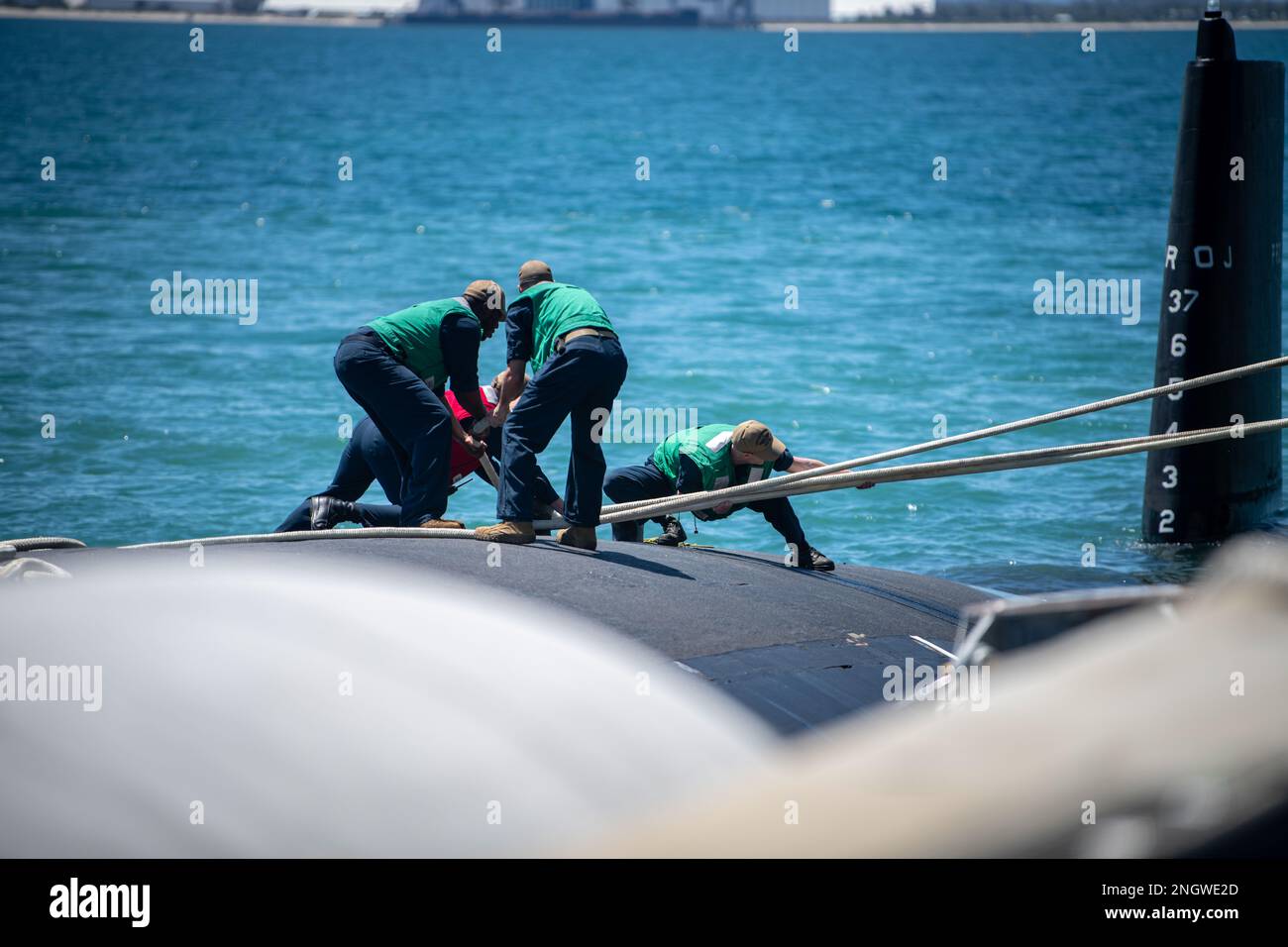 GARDEN ISLAND, Australia - Sailors from the Virginia-class fast-attack submarine USS Mississippi (SSN 782) handle line after the ship moored at Royal Australian Navy HMAS Stirling Naval Base, Nov. 28. Mississippi is currently on patrol in support of national security interests in the U.S. 7th Fleet area of operations. Stock Photo