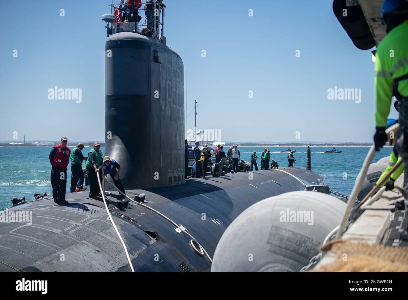 GARDEN ISLAND, Australia - Sailors from the Virginia-class fast-attack submarine USS Mississippi (SSN 782) handle line after the ship moored at Royal Australian Navy HMAS Stirling Naval Base, Nov. 28. Mississippi is currently on patrol in support of national security interests in the U.S. 7th Fleet area of operations. Stock Photo