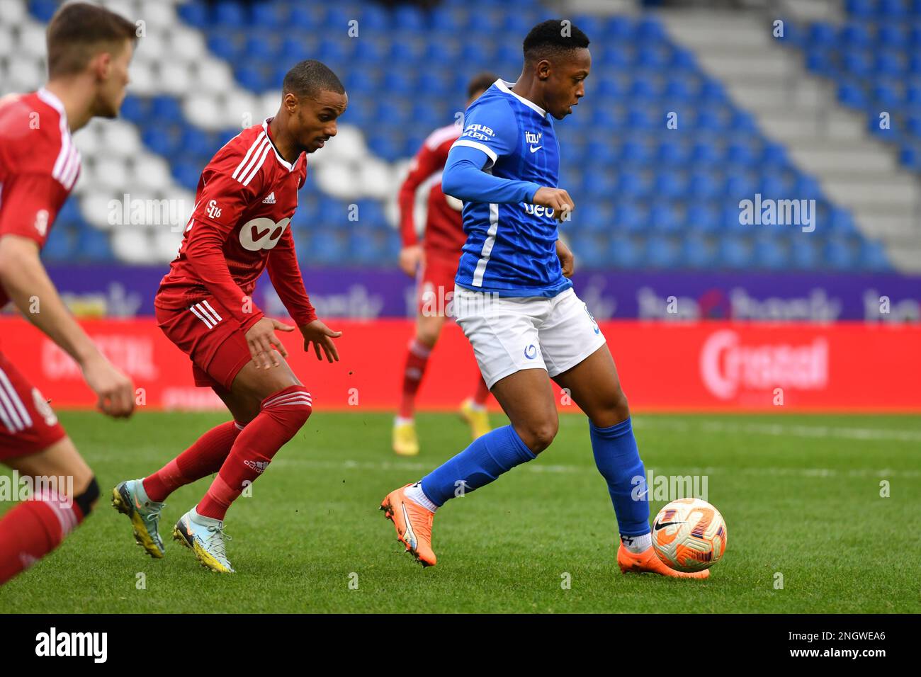 SL16's Frederic Duplus and Jong Genk's Kelvin Pius John pictured in action during a soccer match between Jong Genk (U23) and SL16 (Standard U23), Sunday 19 February 2023 in Lommel, a postponed game of day 19 of the 2022-2023 'Challenger Pro League' 1B second division of the Belgian championship. BELGA PHOTO JILL DELSAUX Stock Photo