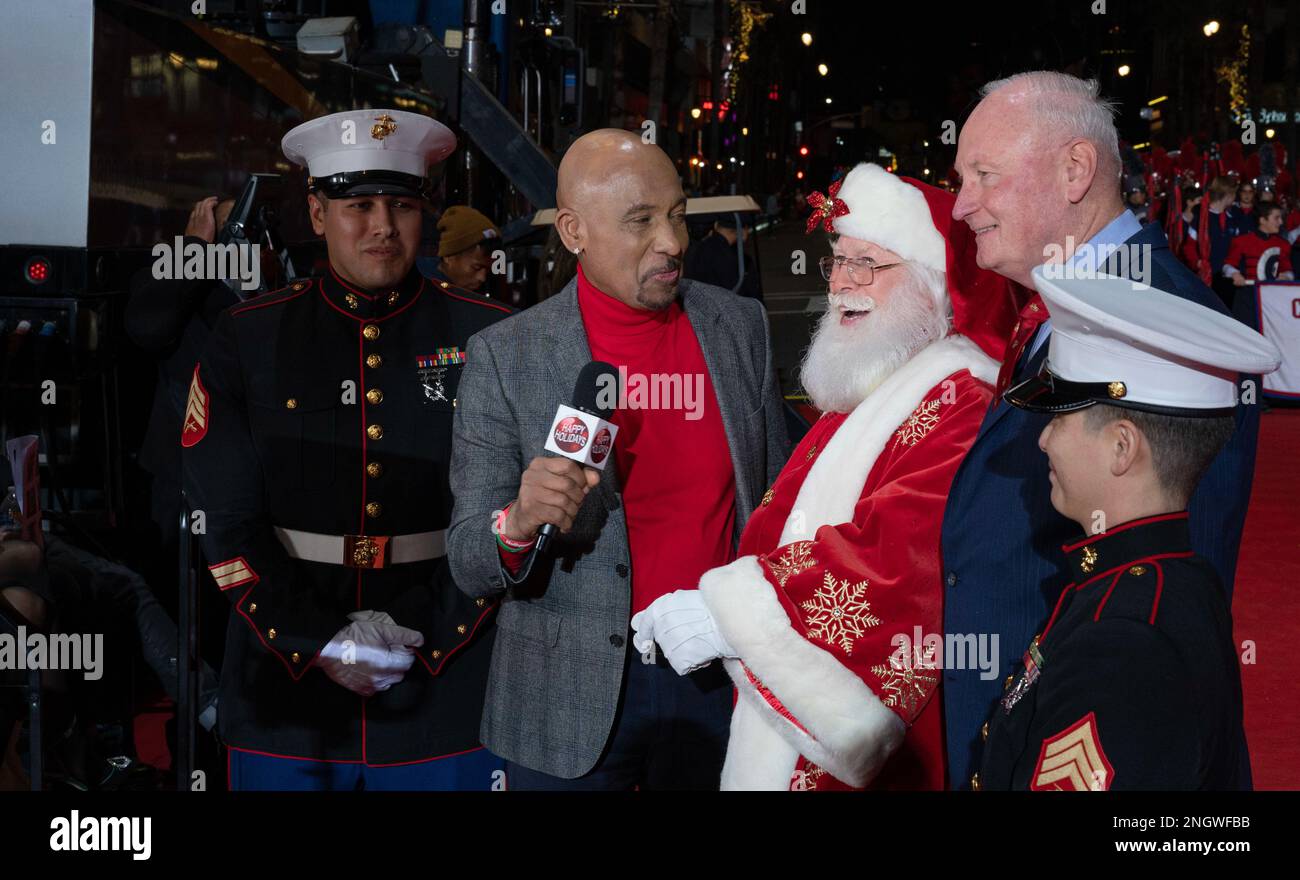 LOS ANGELES (Nov. 27, 2022) Montel Williams, middle left, interviews Tim Connaghan, National Santa, middle, and retired U.S. Marine Corps Lt. Gen. James B. Laster, President and CEO of Marine Toys for Tots Foundation, during the 90th Annual Hollywood Christmas Parade Supporting Marine Toys for Tots, Nov. 27 2022. Marine Toys for Tots, celebrating it's 75th year anniversary, distributes an average of 18 million toys to 7 million less fortunate children each year. Stock Photo