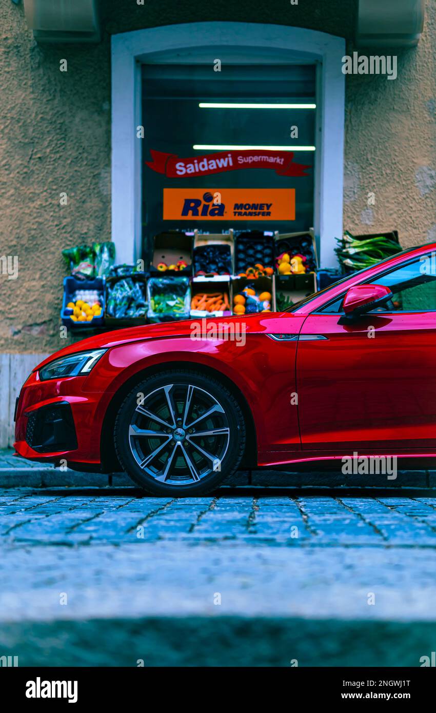 red audi s3 car in front of a small fruit shop business Stock Photo