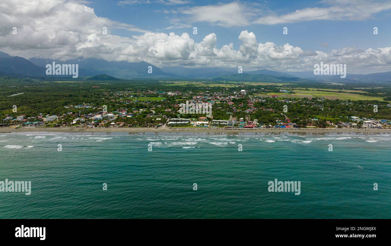 Aerial view of sandy beach and ocean waves. Coastline with hotels and