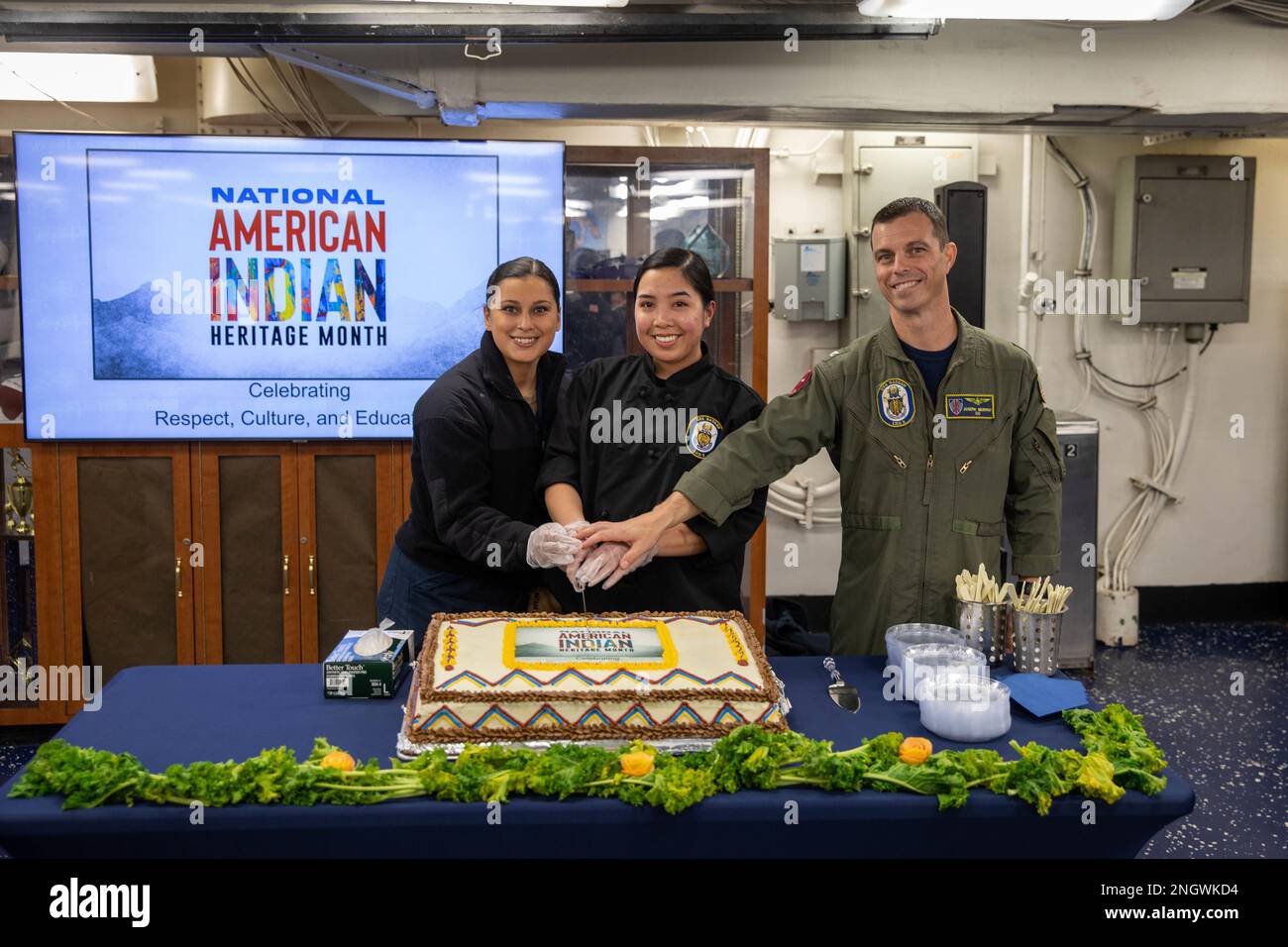 221129-N-OM737-1112  NORFOLK, Va. (Nov. 29, 2022) Capt. Joseph Murphy, commanding officer of the Wasp-class amphibious assault ship USS Bataan (LHD 5), ceremoniously cuts a cake with USS Bataan Sailors during the ship’s National American-Indian Heritage Month celebration on the ship’s mess decks, Nov. 29, 2022. The Bataan also celebrated the event with an invocation and a presentation. Stock Photo