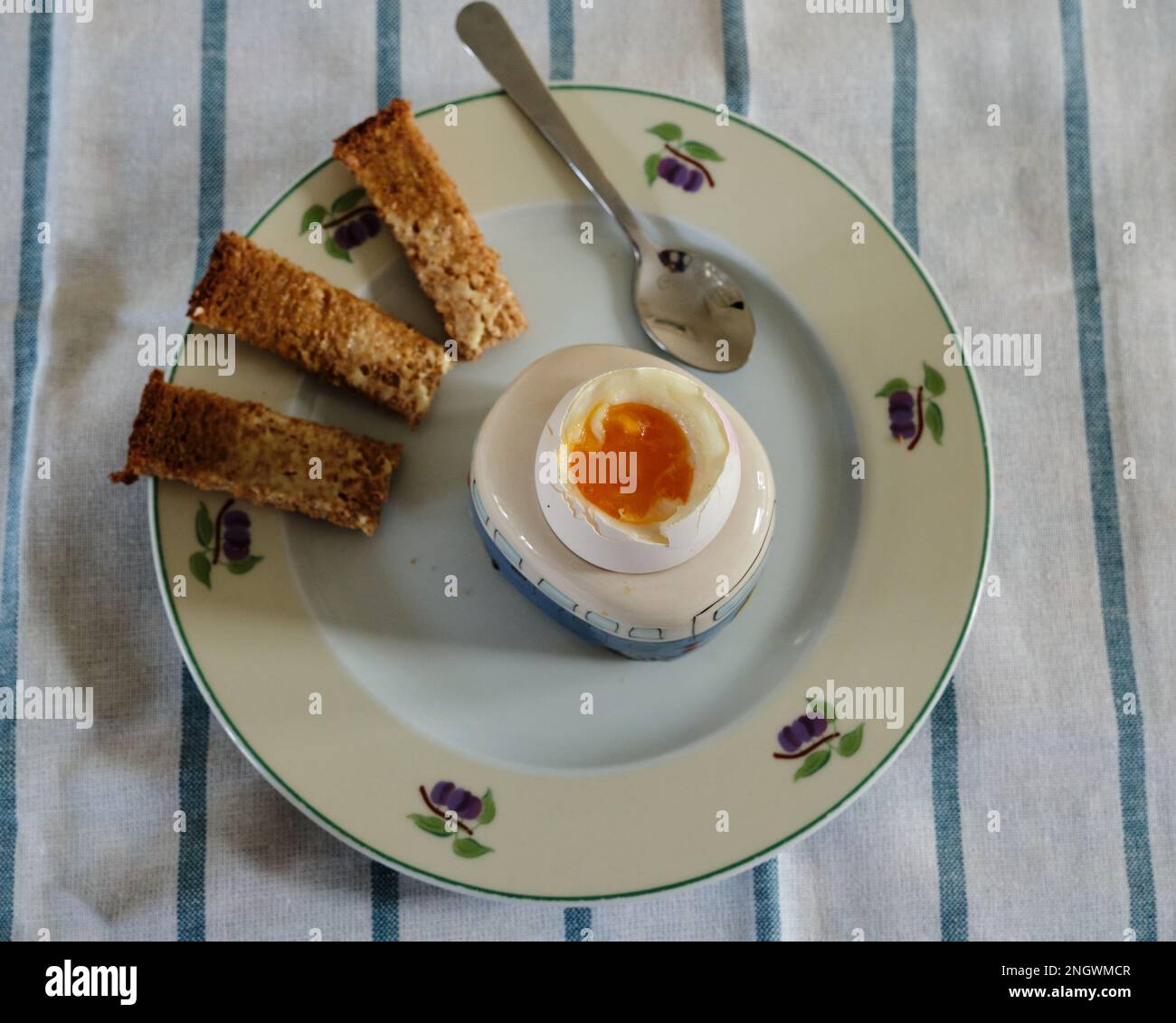 Boiled Egg for Breakfast with toast soldiers and egg spoon Stock Photo