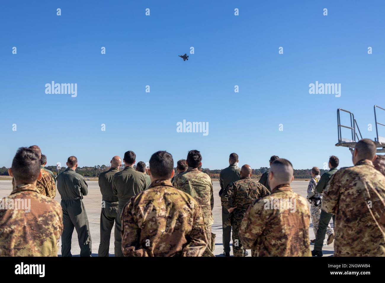 U.S. Marines and Italian F-35B pilots and maintainers watch a F-35B fighter jet demo during an Italian Delegation at Marine Corps Air Station Beaufort, South Carolina, Nov. 29, 2022. Marine Fighter Attack Squadron 501 helped support the Italian Navy F-35B pilots and maintainers and assisted in the development of their organic F-35B training program that will be located at Amendola Air Base, Italy. Stock Photo