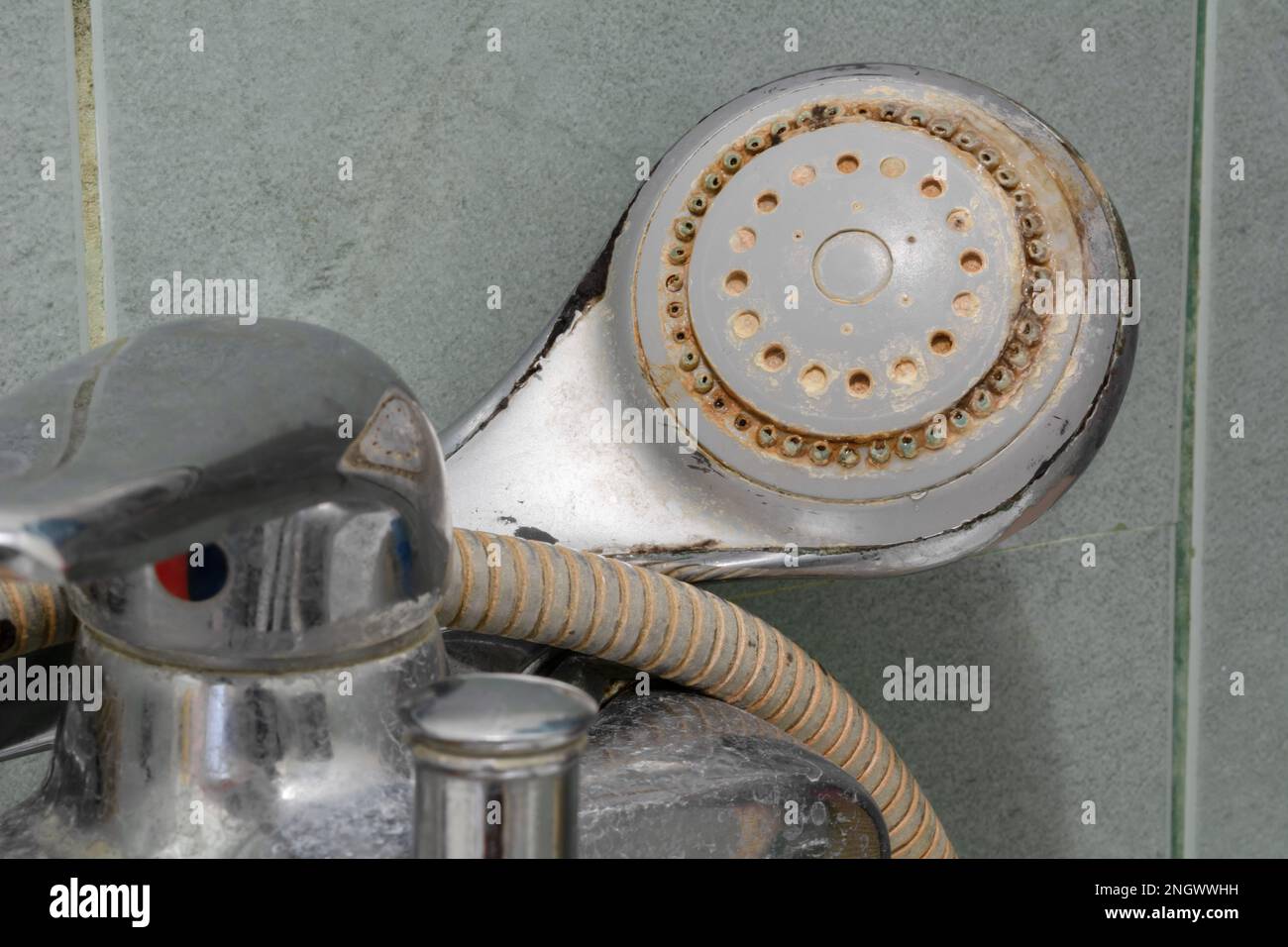 Shower limescale. Dirty shower head with limescale and rust. Selective
