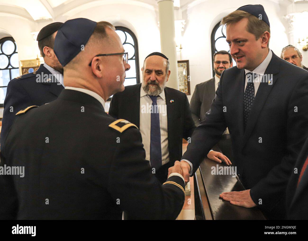 WARSAW, Poland - U.S. Army V Corps Chaplain Col. Benjamin Sprouse, left, shakes the hand of Vasyl Zwarycz, Ambassador of Ukraine to Poland, before the dedication of a Torah Scroll to the Ukrainian Army commences, Nov. 29, 2022, Warsaw, Poland. Jewish Chaplains alongside distinguished guests, refugees from Ukraine, and U.S. ally partner nations attended the event to support the Ukrainian Chaplaincy’s religious support efforts. Stock Photo