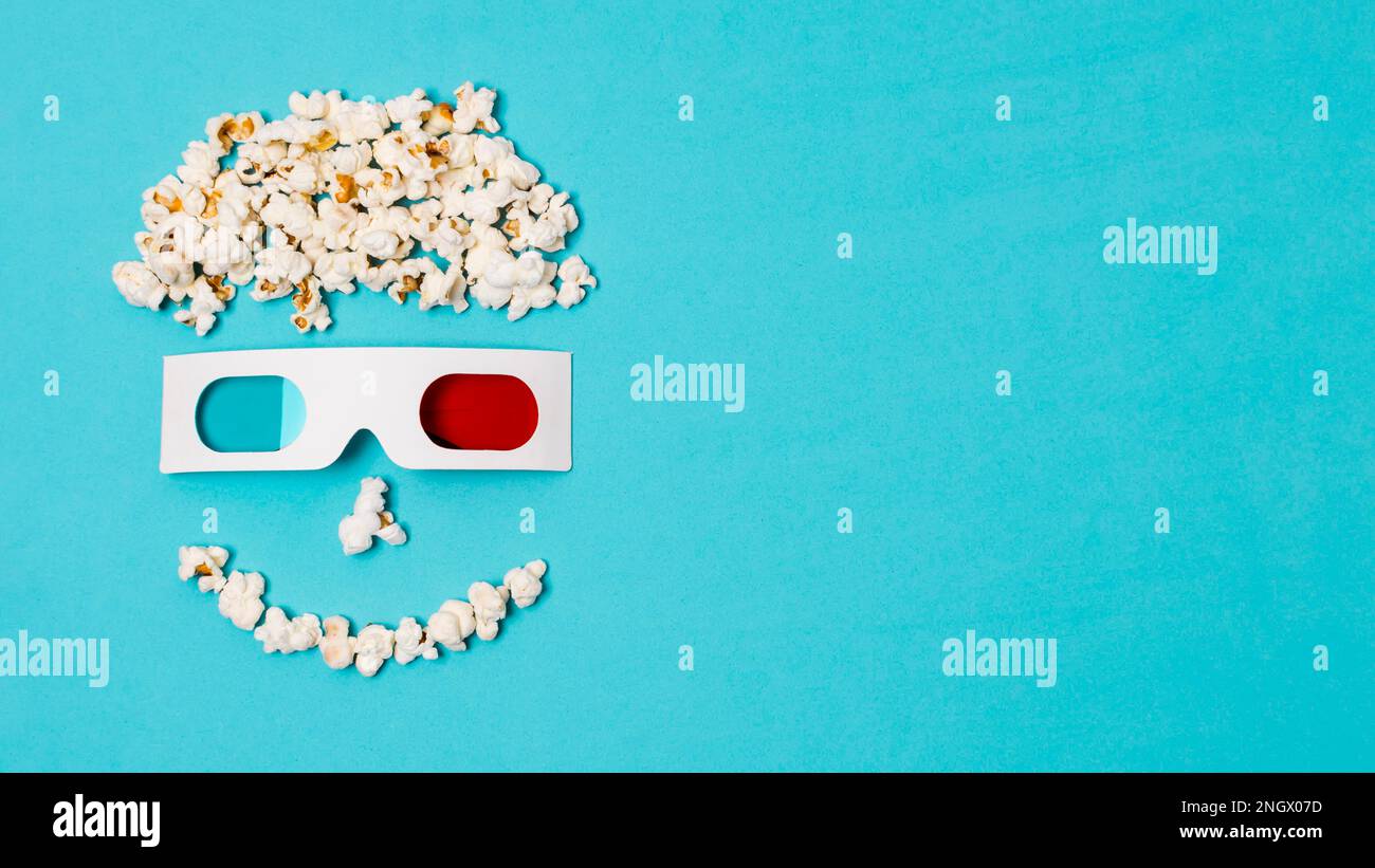 smiley anthropomorphic face made with popcorns 3d glasses cinema time text. High resolution photo Stock Photo