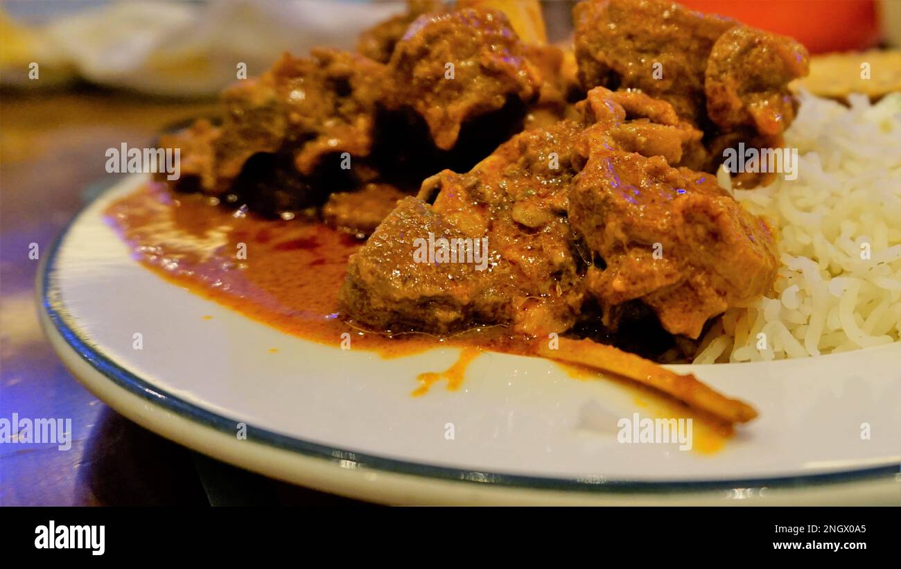Closeup of Spicy Rogan josh mutton or goat curry with aromatic Basmati rice or Chawal Stock Photo