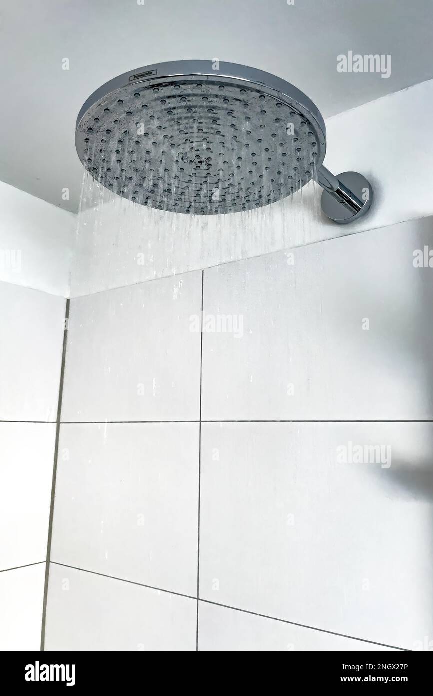 Running water from in shower with large shower head type rain shower