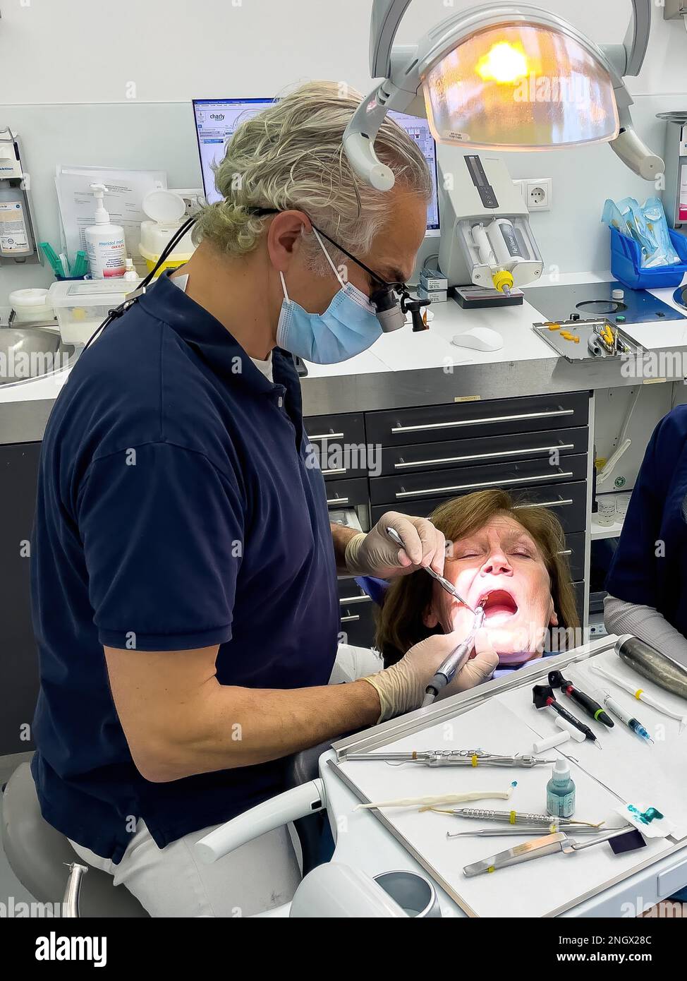 Dentist does dental prophylaxis performs dental treatment caries