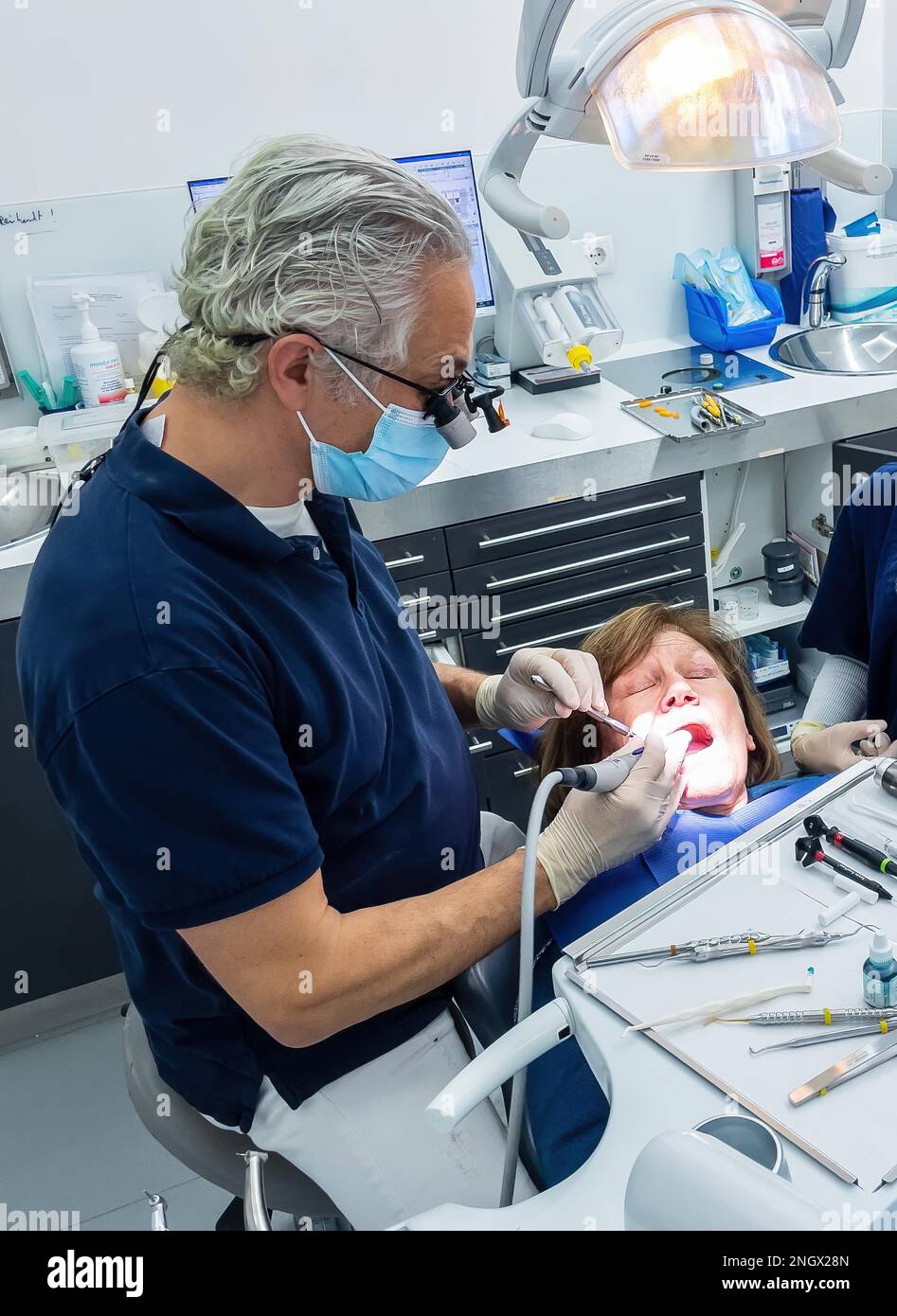 Dentist does dental prophylaxis performs dental treatment caries