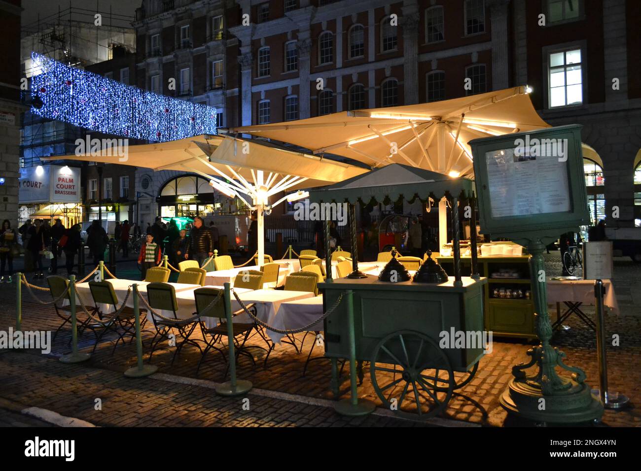Covent Garden 'Laduree' cafe outdoor interior waiting to be opened with beautiful LED lights decoration of the square in dark hour. Stock Photo