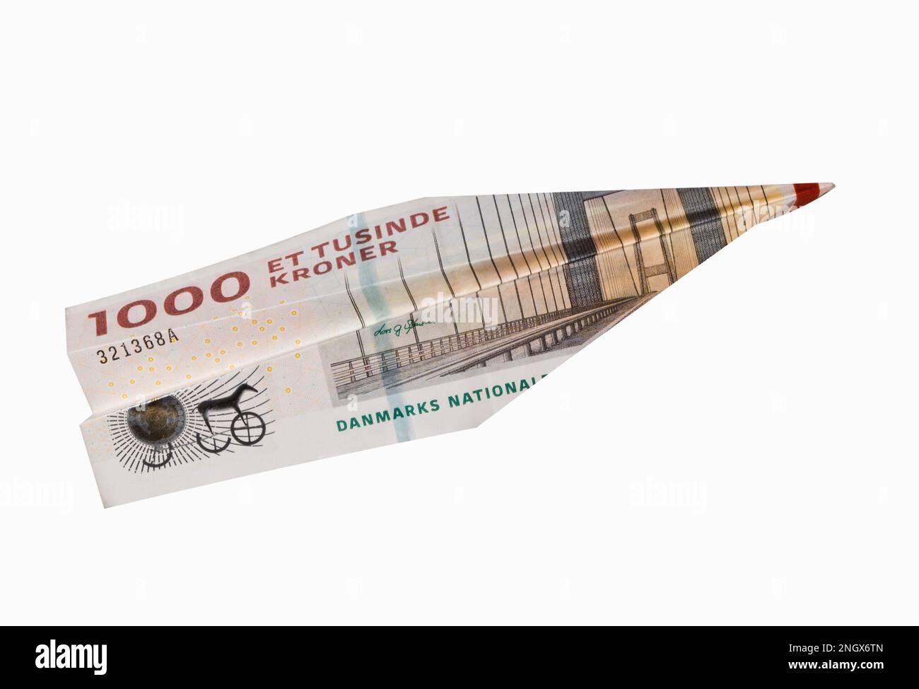 Cash Danish Krone banknote folded into airplane isolated on white background. Express DKK money transfer or bank payment. Travel cost in Denmark. Stock Photo
