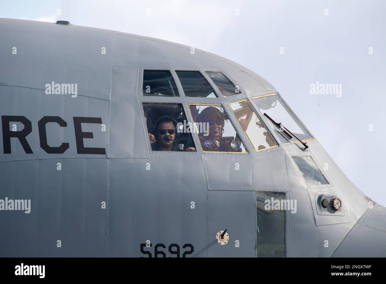 Crew members with the 36th Expeditionary Airlift Squadron wave from a C-130J Super Hercules after landing at Andersen Air Force Base, Guam, Nov. 30, 2022, during Operation Christmas Drop 2022. Operation Christmas Drop 2022. OCD is the longest-running Department of Defense humanitarian and disaster relief mission. Stock Photo
