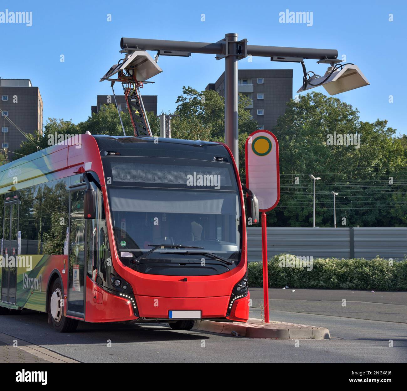 Electrical bus recharging at an overhead charging bus stop Stock Photo