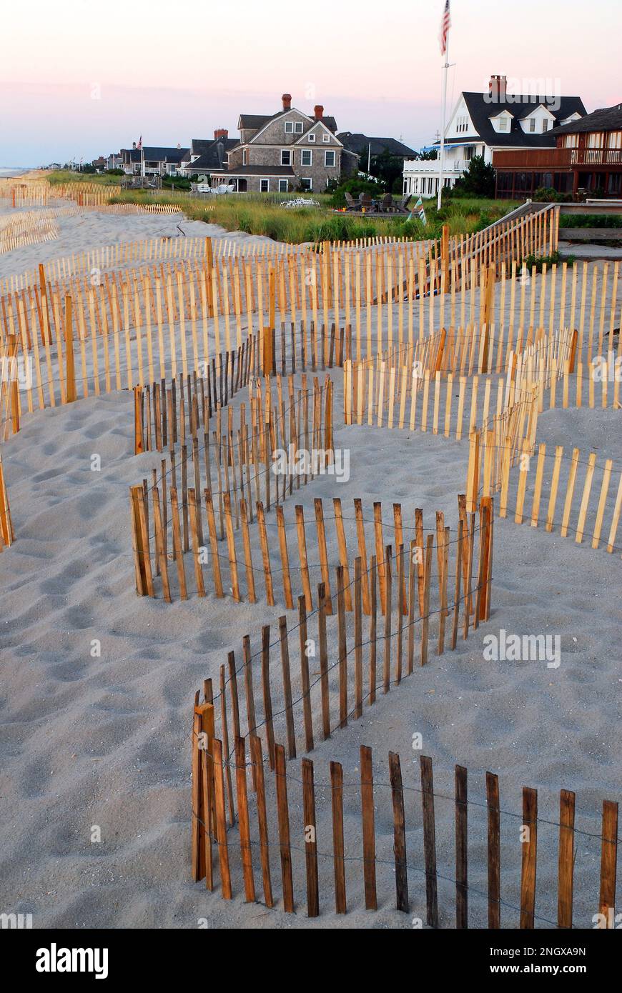 A snow fence protects the dunes that protect the summer homes on the Jersey Shore from storms and erosion Stock Photo