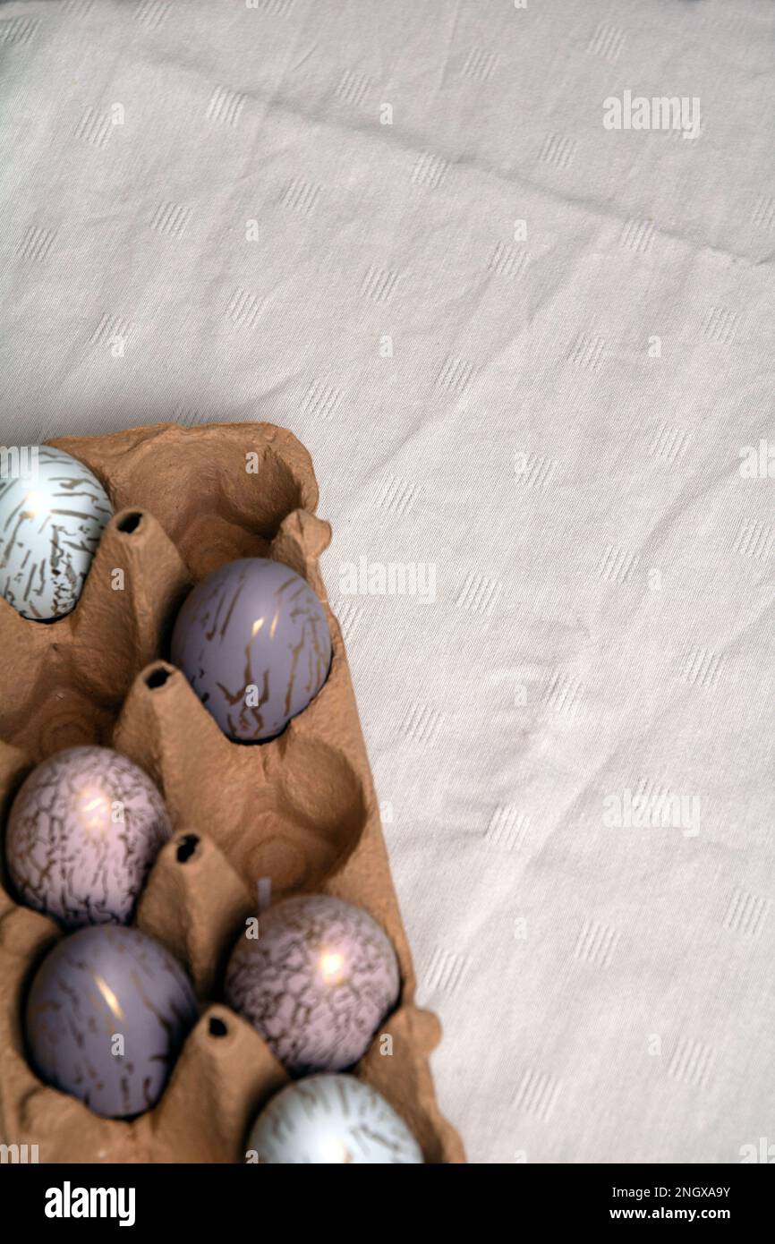 photo multicolored chicken eggs lying in a tray on a table Stock Photo