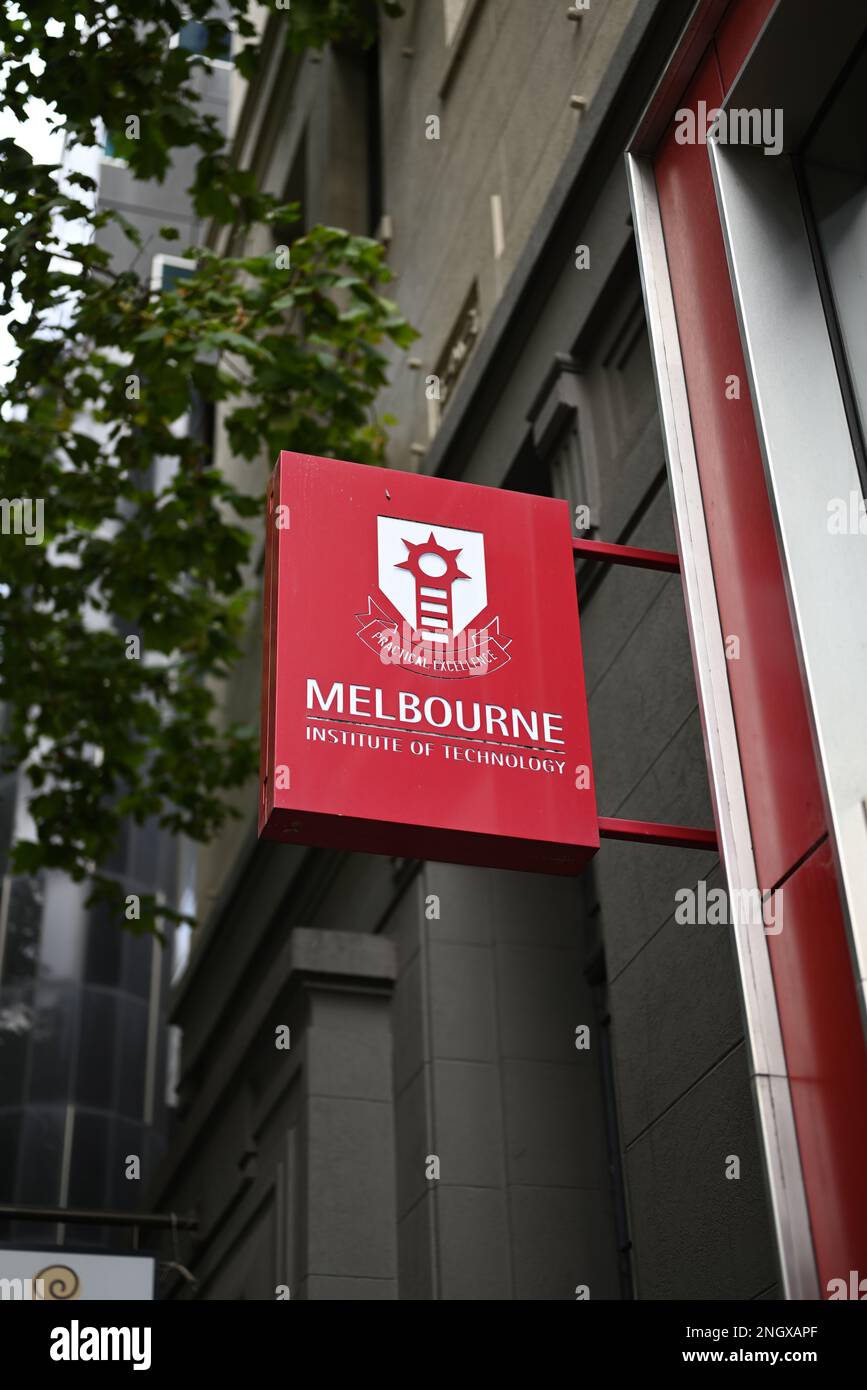 Red Melbourne Institute of Technology sign, featuring logo and motto, outside one of the education institution's city campuses Stock Photo