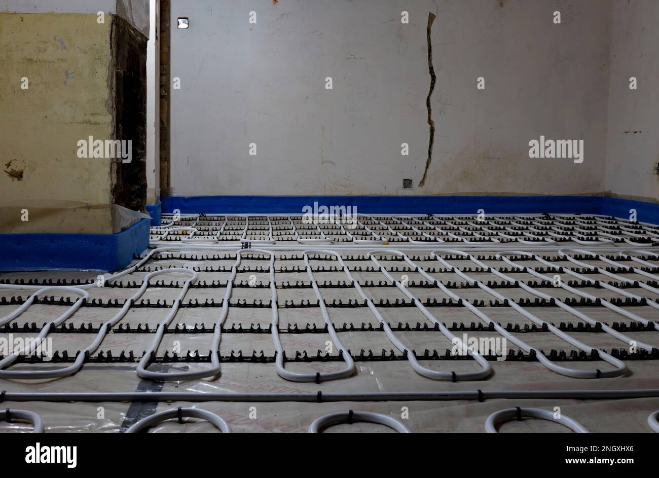 Underfloor heating pipework clipped down on insulation with plastic