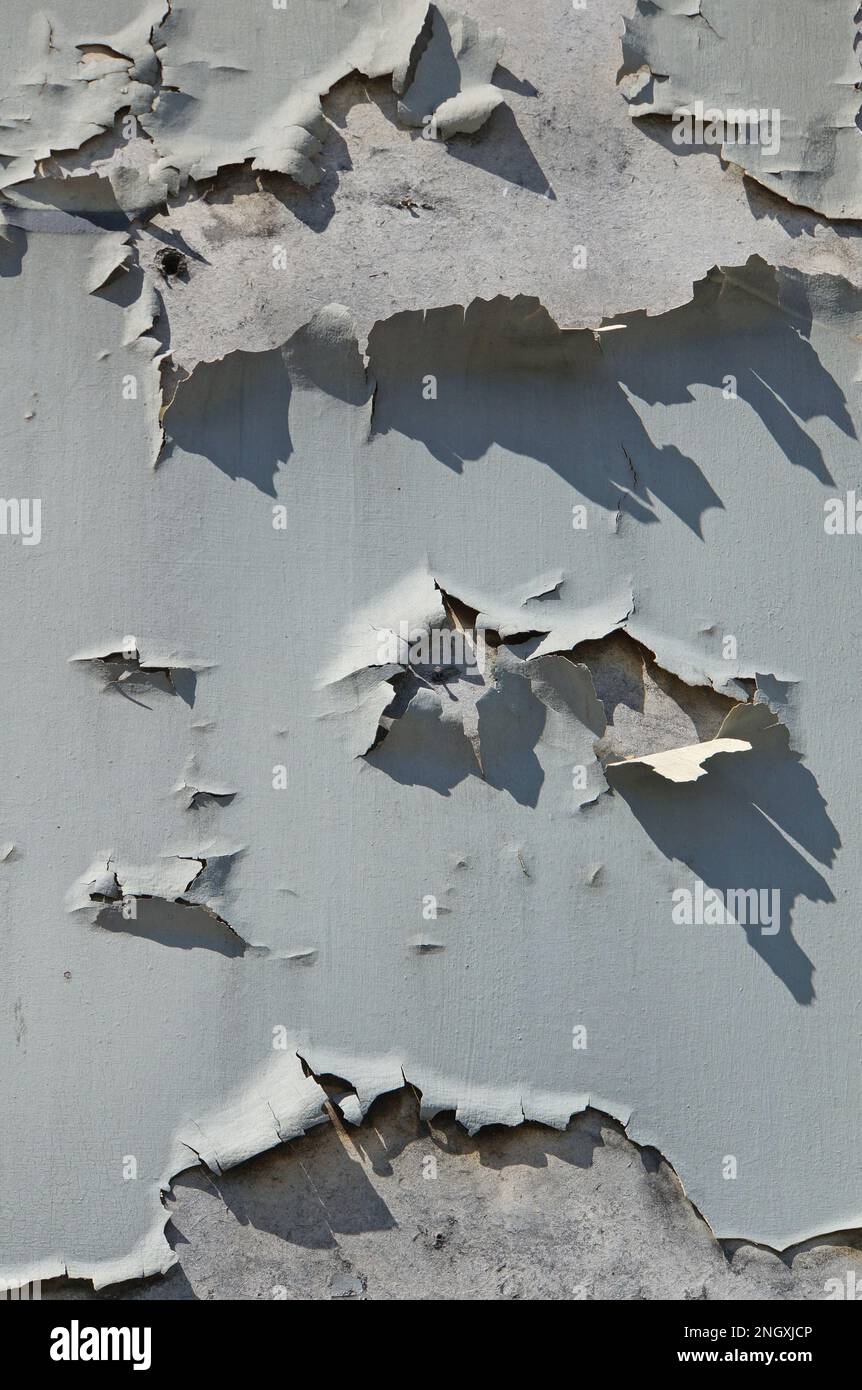 Old blue peeling paint on a wall, textured background Stock Photo
