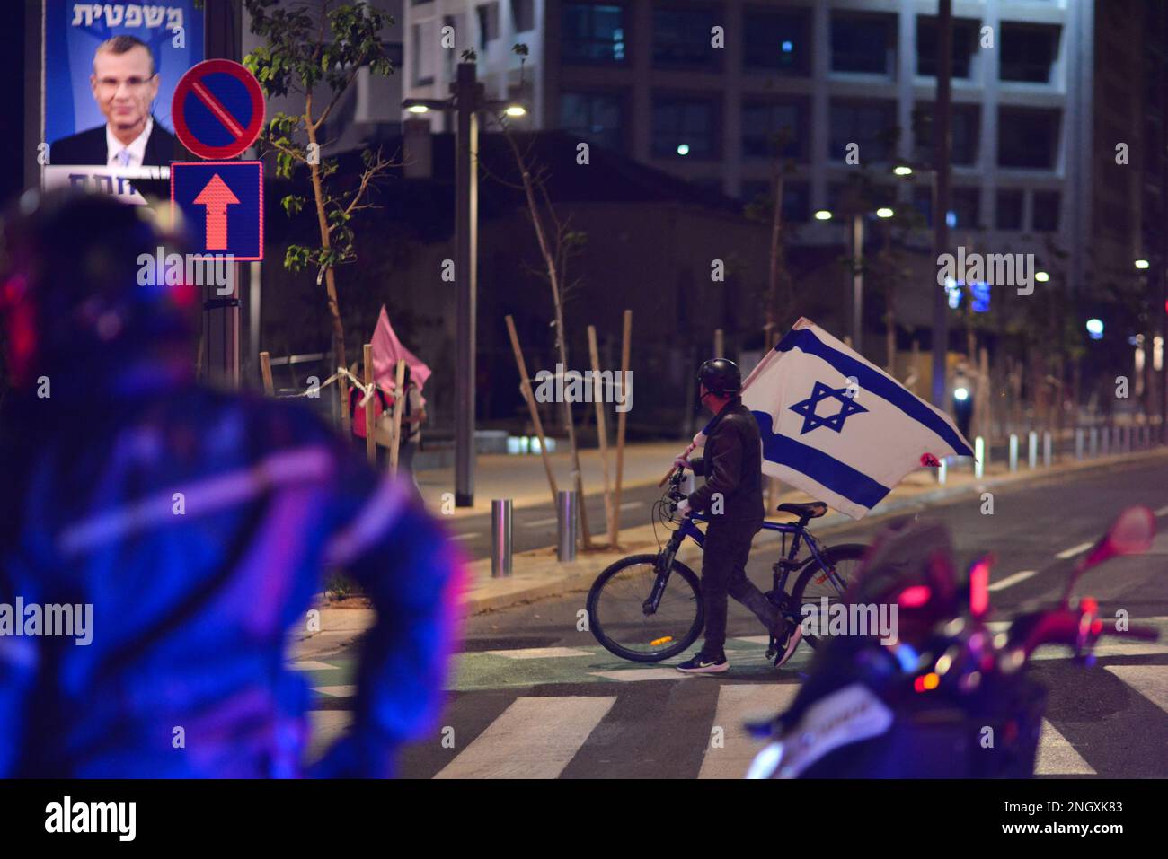 Israel. 18th Feb, 2023. A protestor against the reform next to an urban signboard in support with Yariv Levin, Israeli minister of justice. Over 120,000 people protested in Tel Aviv against Netanyahu's far-right government and its controversial legal reform. Feb 18th 2023. (Photo by Matan Golan/Sipa USA). Credit: Sipa USA/Alamy Live News Stock Photo