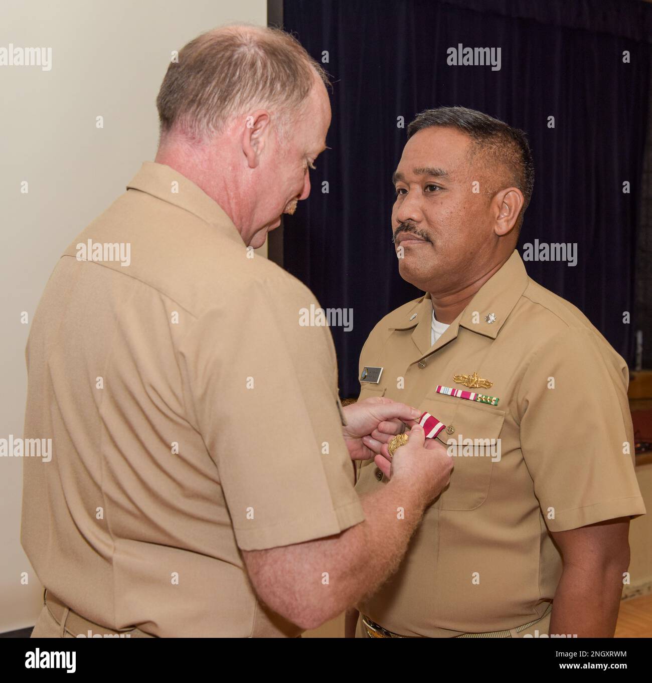 221130-N-EJ241-1032    Cmdr. Robert E. Bulatao, executive officer of U.S. Navy Support Facility (NSF) Diego Garcia, receives a Meritorious Service Medal from Capt. John F. Wilson, commanding officer of NSF Diego Garcia, during a frocking ceremony at Diego Garcia Dec. 30, 2022. NSF Diego Garcia provides logistic, service, recreational, and administrative support to U.S. and allied forces forward deployed to the Indian Ocean and Arabian Gulf. Stock Photo