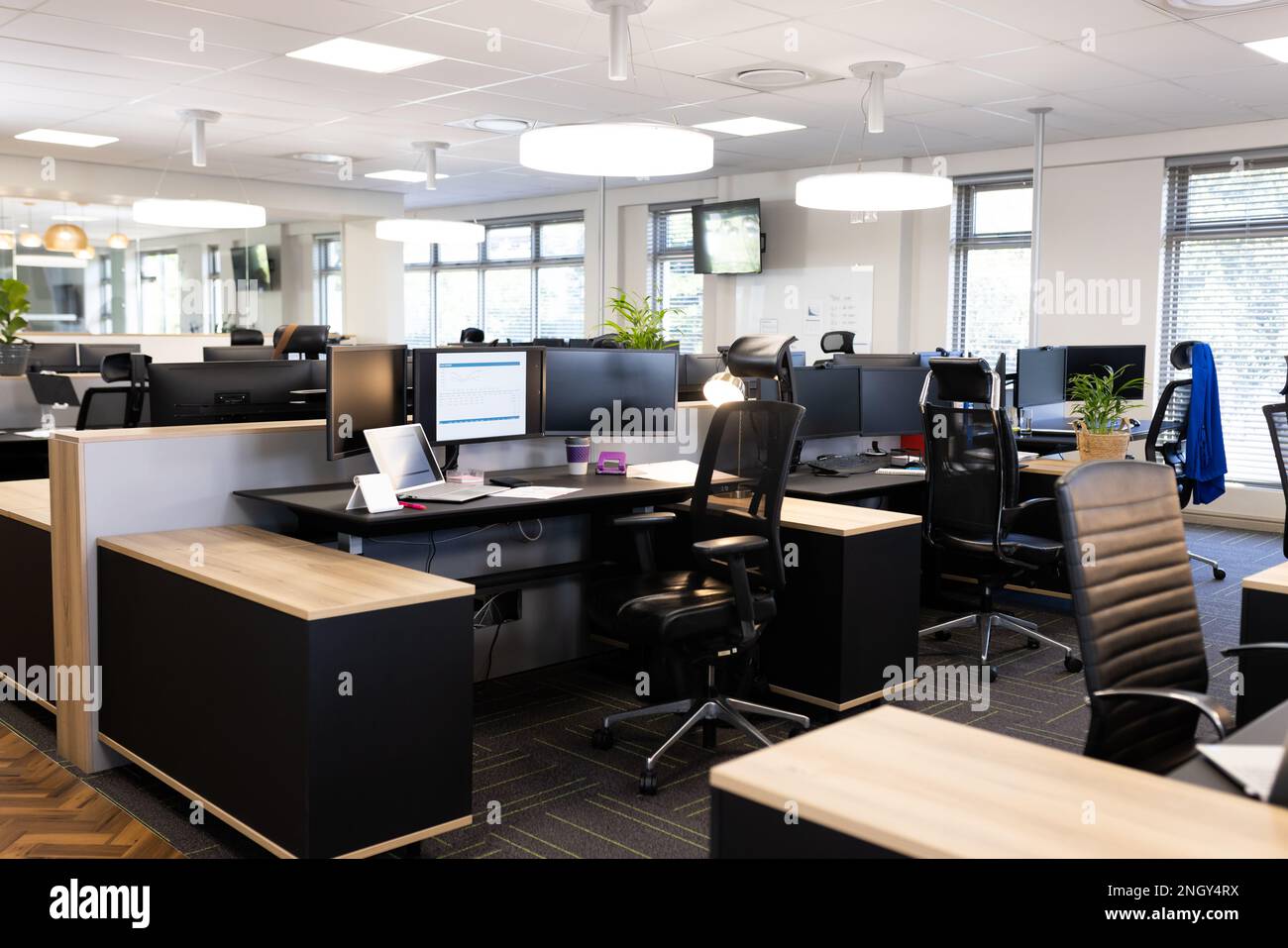Empty open space office with desks, chairs and computers Stock Photo