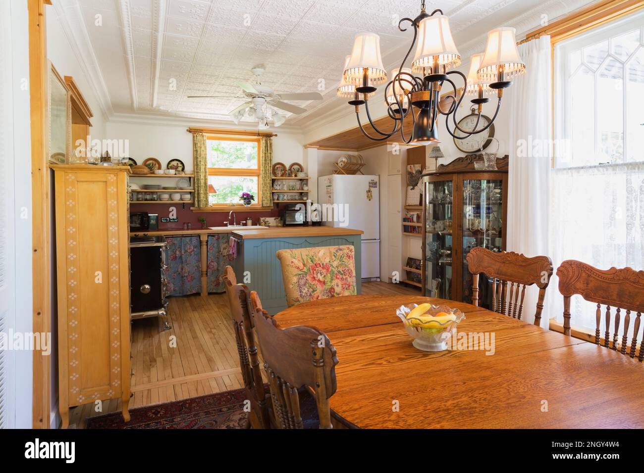 Oval oak wood dining table with pressback chairs, pinewood and glass
