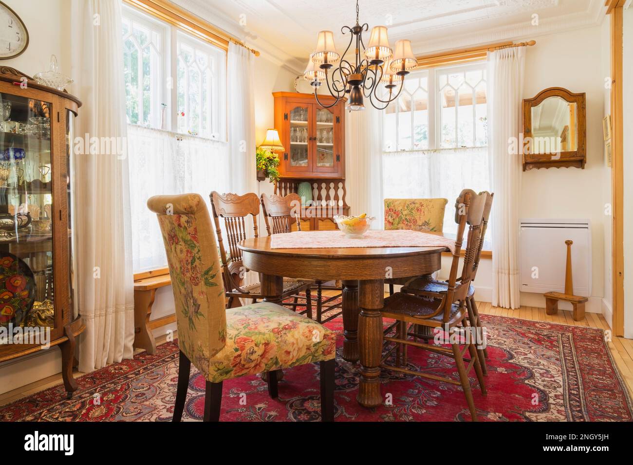 Oval oak wood dining table with pressback chairs, wood with glass