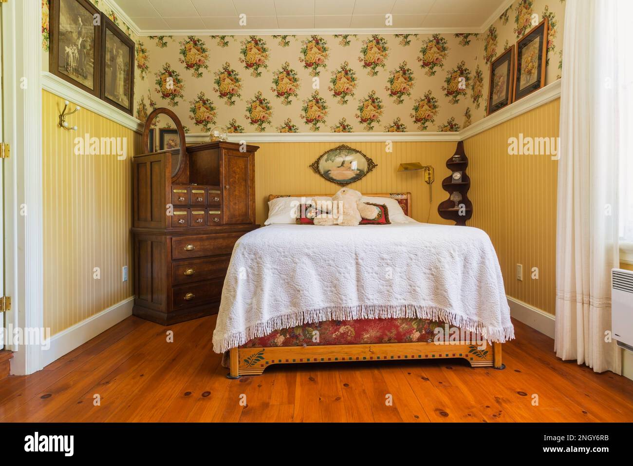 1930s double bed with pine wood headboard, white bedspread, antique