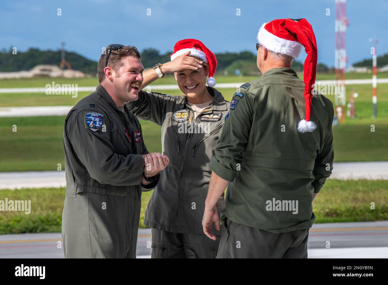 (Left to right) U.S. Air Force Capt. Andrew Zaldivar, 36th Expeditionary Airlift Squadron, greets Royal New Zealand Air Force Flight Lieutenant Michal-Louise Paget and Flight Lieutenant Campbell Wilson at Andersen Air Force Base, Guam, Dec. 1, 2022, during Operation Christmas Drop 2022. Operation Christmas Drop is the longest-running Department of Defense humanitarian mission that delivers critical aid to island communities throughout the western Pacific while also providing an opportunity for aircrew to hone important skills needed for future operations. Stock Photo