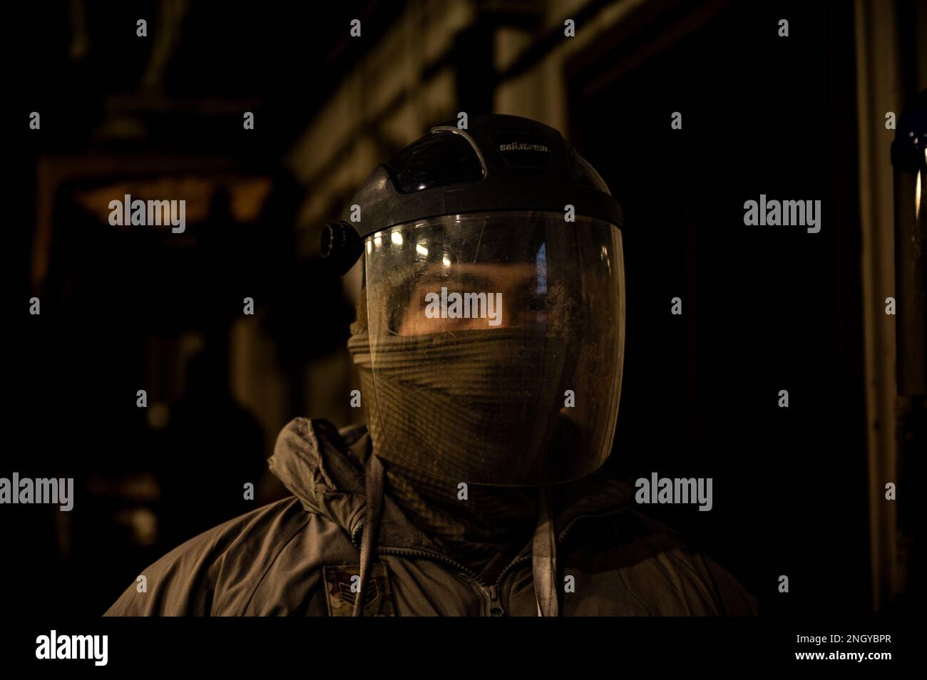 U.S. Air Force Staff Sgt. Zachary Smith, 51st Logistics Readiness Squadron fuels distribution supervisor dons protective gear before performing morning checkpoint inspections at Osan Air Base, Republic of Korea, Dec. 1, 2022. During checkpoint inspections, members of the LRS fuels flight perform safety checks on R-11 refueler trucks and quality checks on the fuel onboard before heading out on the flight line for distribution. Stock Photo