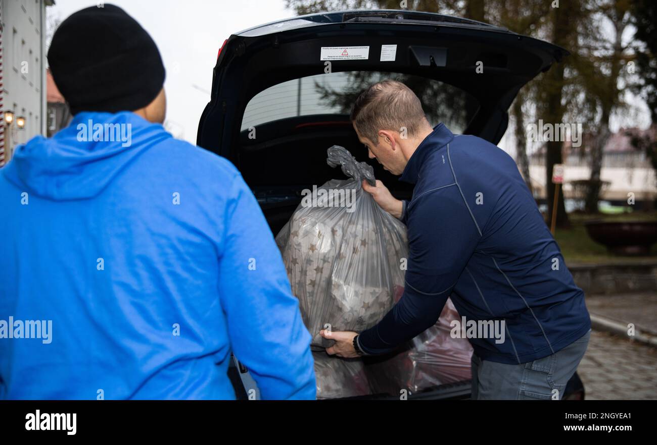 U.S. Army Capt. Dennis Stene, chaplain of Headquarters and Headquarters Battalion (HHBN), 1st Infantry Division (1 ID) , and U.S. Army Cpl. Bennie Long, a battalion religious affairs noncommissioned officer HHBN, 1 ID, loads a vehicle with gifts collected by Soldiers during a toy drive held in Bolesławiec, Poland, Dec. 1, 2022. The gifts were donated to children living at the Dom Dziecka P.W. Sw. Jozefa Zgromadzenia Sióstr Elżbietanek, the Orphanage of St. Joseph of the Congregation of the Elizabethan Sister, by Soldiers assigned to the 1 ID who are working in communities of NATO allies and re Stock Photo
