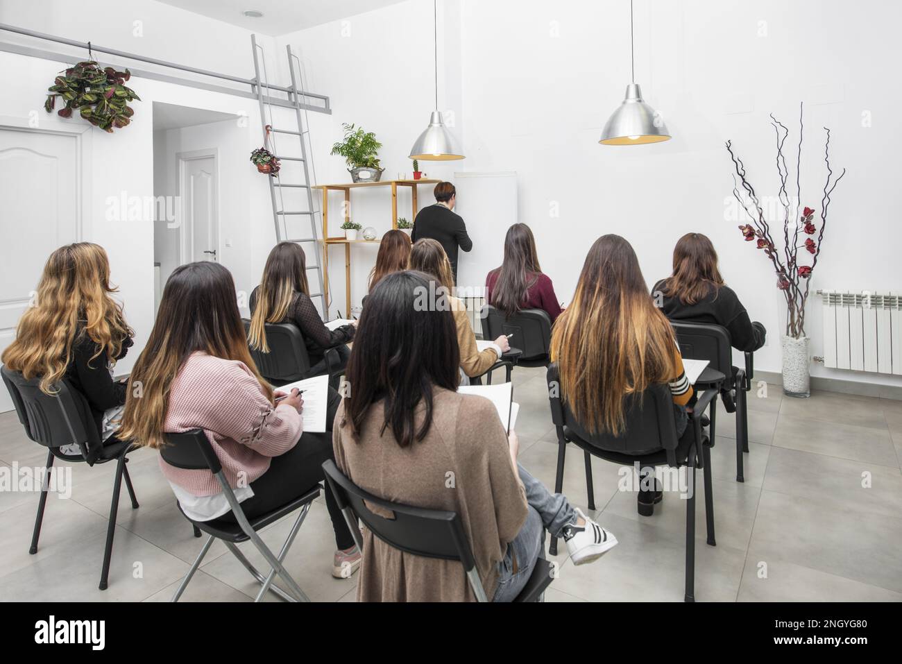 Classroom full of attentive female students looking at the teacher Stock Photo
