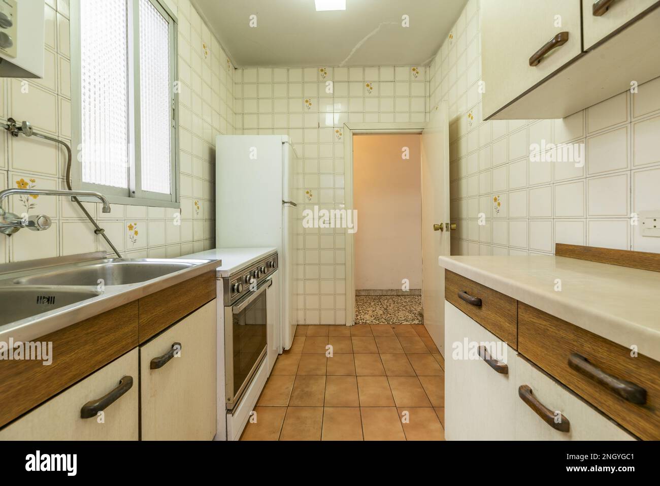 Old kitchen with old furniture in poor condition, white fridge, vintage ...