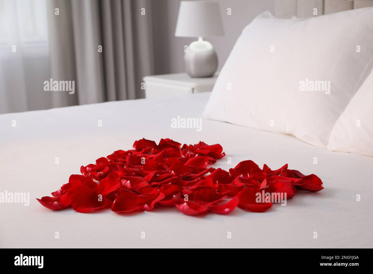 Beautiful heart of red rose petals on bed in room Stock Photo Alamy
