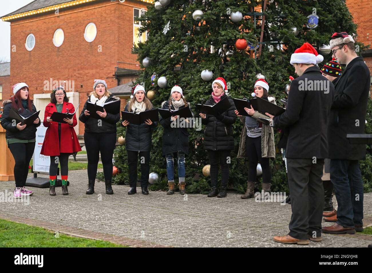 Christmas carolers sing before the annual Christmas tree lighting ceremony Dec. 1, 2022, at Royal Air Force Mildenhall, England. The carolers sang many popular Christmas songs throughout the evening. Stock Photo