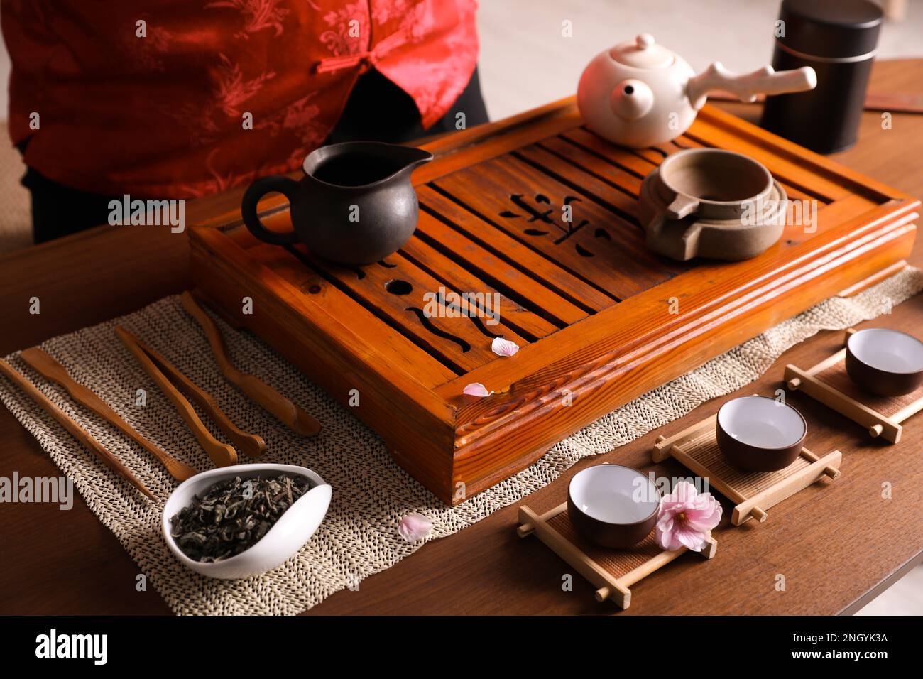 Traditional tea ceremony. Master at table with utensils, closeup. Tray
