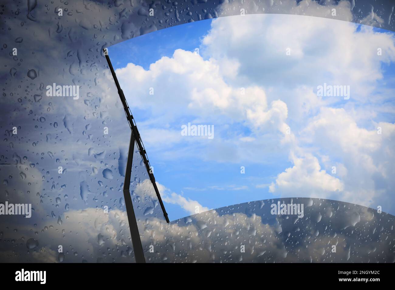 Man removing dirt from glass with squeegee. View of blue sky