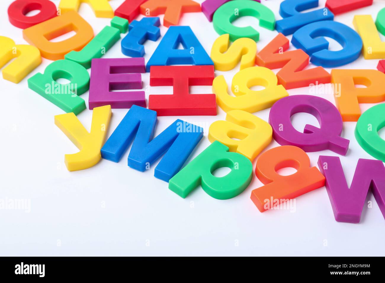 Many colorful magnetic letters on white background Stock Photo - Alamy