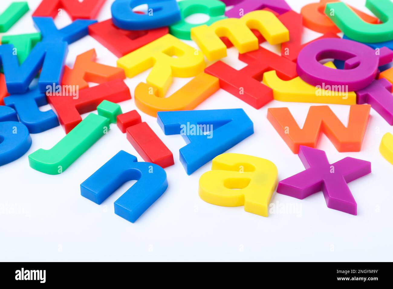 Many colorful magnetic letters on white background Stock Photo - Alamy