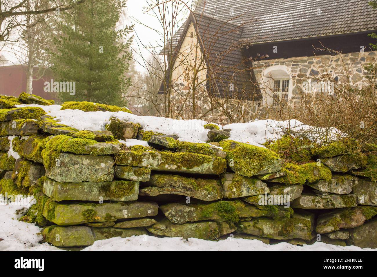 old-stone-fence-around-a-medieval-church-in-messukyl-tampere-finland