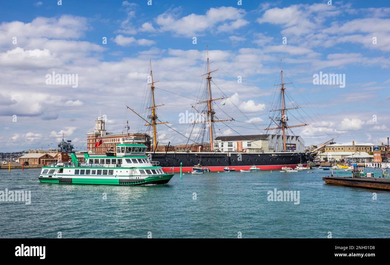 a Gosport Ferry passes museum ship HMS Warrior at the Portsmouth Historic Dockyard, Hampshire, South East England Stock Photo